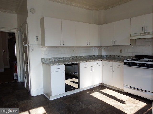 kitchen featuring gas range gas stove, white cabinets, tasteful backsplash, and light stone countertops