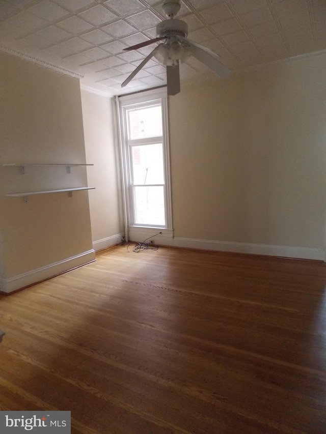 spare room with hardwood / wood-style flooring and ceiling fan