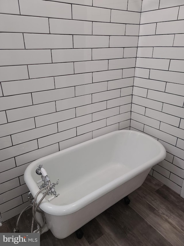 bathroom with a bathing tub and wood-type flooring