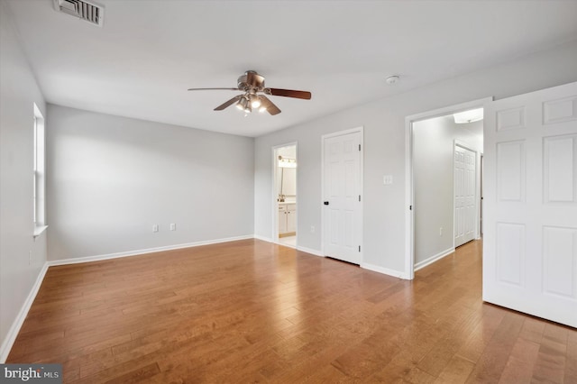 unfurnished room with hardwood / wood-style floors and ceiling fan