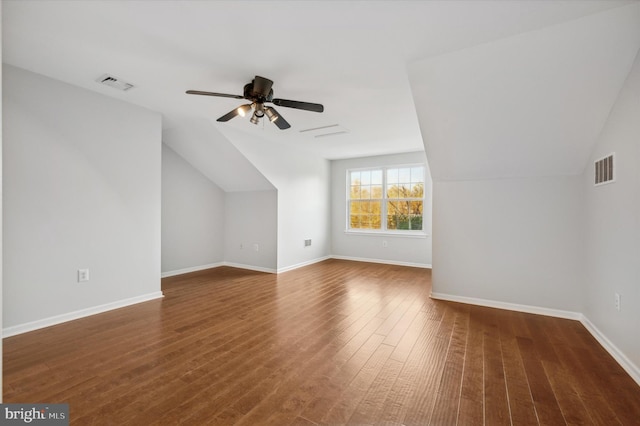 additional living space featuring dark wood-type flooring, ceiling fan, and lofted ceiling