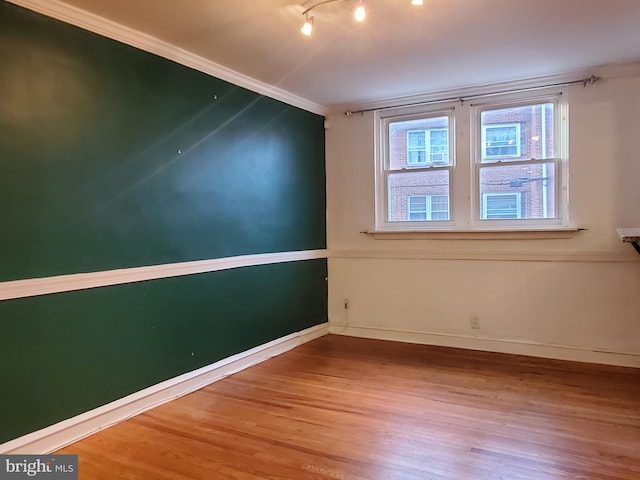 unfurnished room with hardwood / wood-style flooring