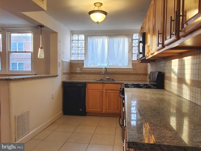 kitchen featuring backsplash, a healthy amount of sunlight, and black appliances