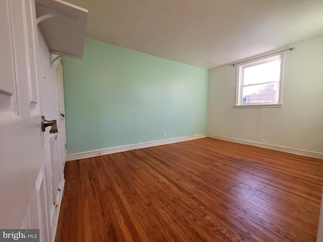 unfurnished room with hardwood / wood-style flooring