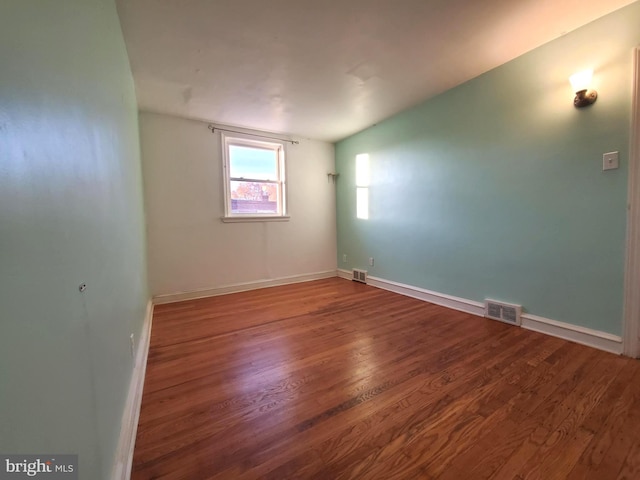 unfurnished room featuring wood-type flooring