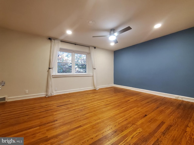 spare room featuring light hardwood / wood-style floors and ceiling fan