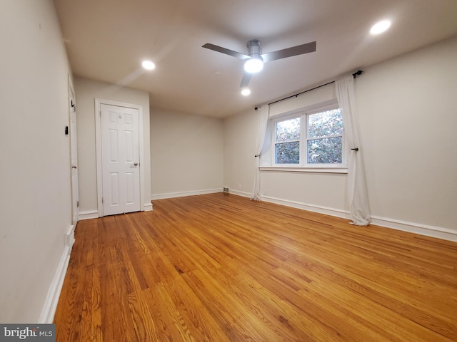 empty room with light wood-type flooring and ceiling fan