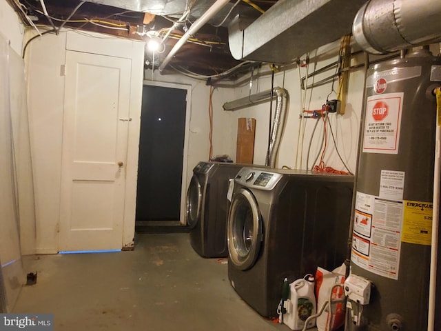 clothes washing area with gas water heater and independent washer and dryer