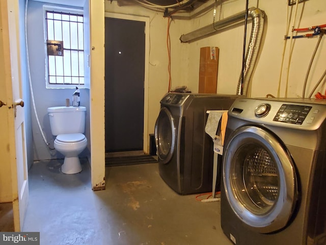 clothes washing area with washer and dryer