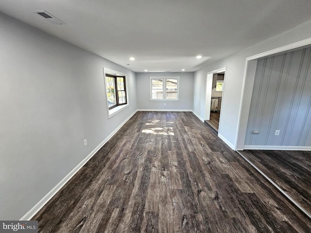 unfurnished living room featuring dark hardwood / wood-style flooring