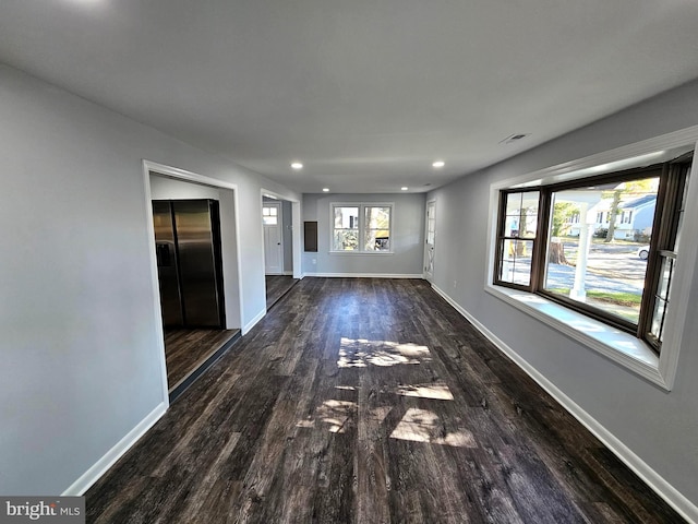 unfurnished living room featuring dark wood-type flooring