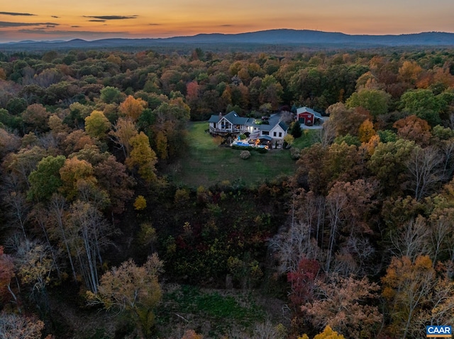 aerial view at dusk featuring a mountain view