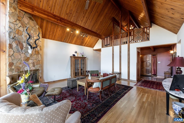 living room with beamed ceiling, hardwood / wood-style flooring, and high vaulted ceiling