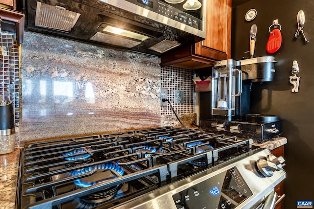 kitchen with appliances with stainless steel finishes and decorative backsplash