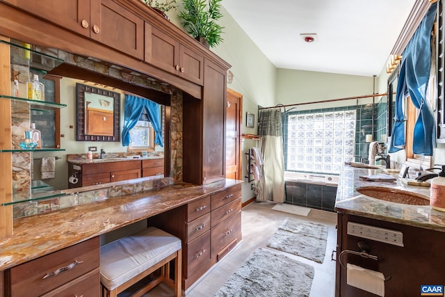 bathroom with vanity, a shower with shower curtain, and vaulted ceiling