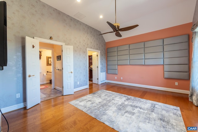 unfurnished bedroom featuring vaulted ceiling, light hardwood / wood-style flooring, and ceiling fan