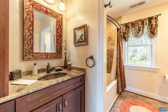 bathroom featuring vanity, shower / bath combination with curtain, and tile patterned floors