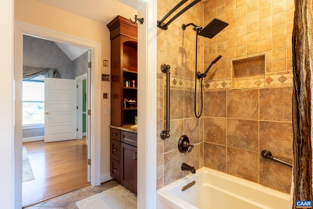 bathroom featuring vanity, shower / bath combo with shower curtain, vaulted ceiling, and hardwood / wood-style floors