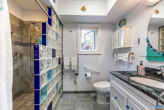 bathroom with vanity, a shower with shower curtain, toilet, and tile patterned floors