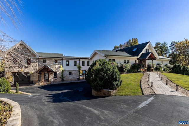 view of front of house with a front lawn and a carport