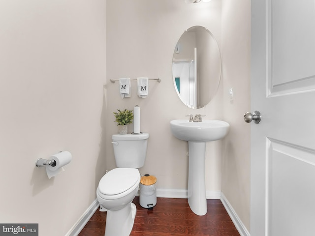 bathroom with toilet and wood-type flooring