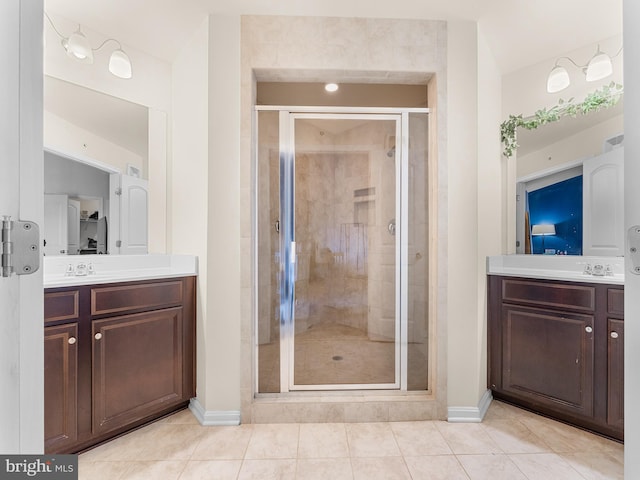 bathroom with vanity, walk in shower, and tile patterned flooring