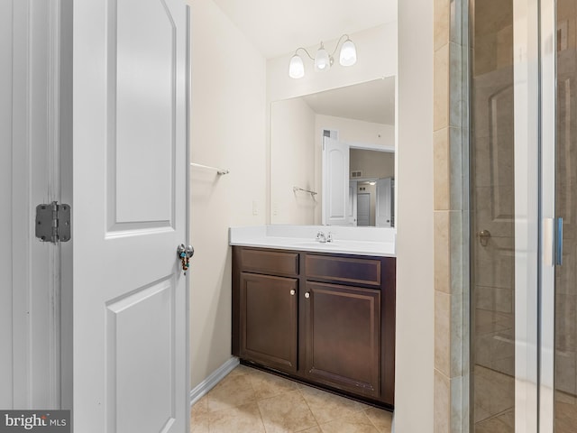 bathroom featuring vanity, tile patterned flooring, and walk in shower