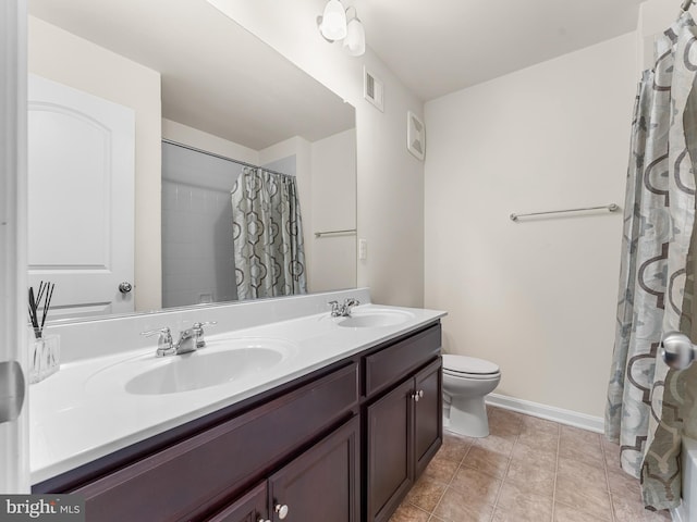 bathroom with vanity, toilet, tile patterned floors, and curtained shower