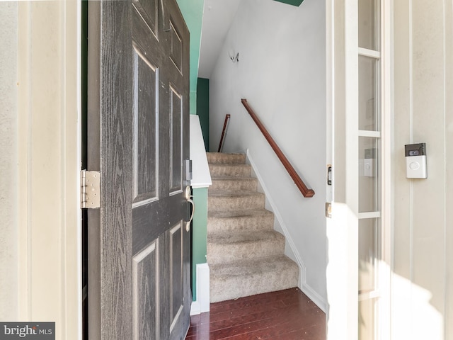 staircase with hardwood / wood-style floors