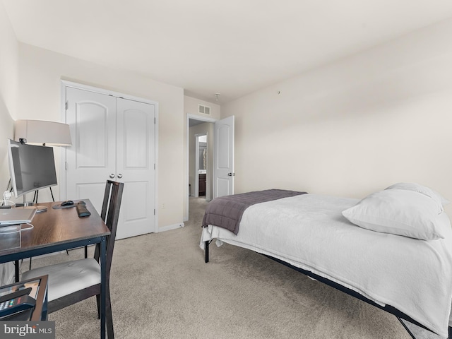 carpeted bedroom featuring a closet