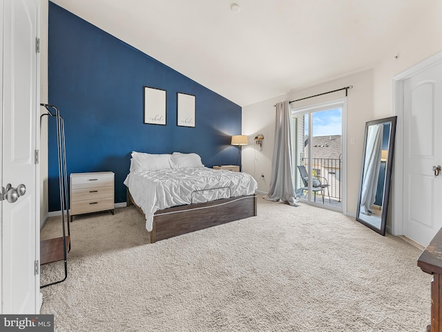 bedroom featuring access to exterior, carpet, and vaulted ceiling