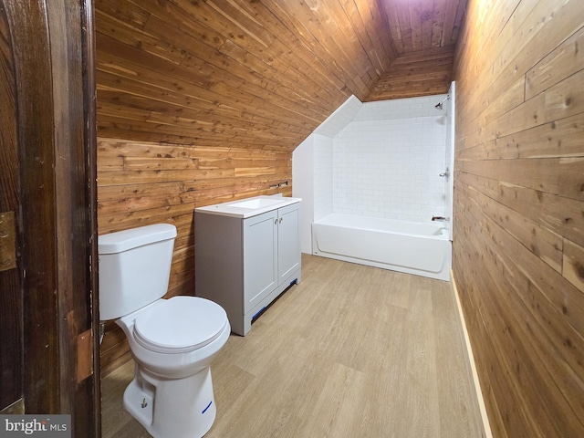 full bathroom featuring wood walls, toilet, wooden ceiling, vaulted ceiling, and vanity