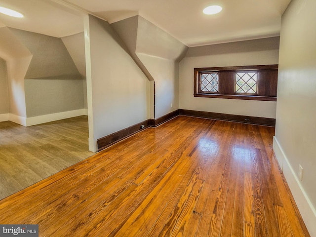 bonus room with lofted ceiling and hardwood / wood-style floors