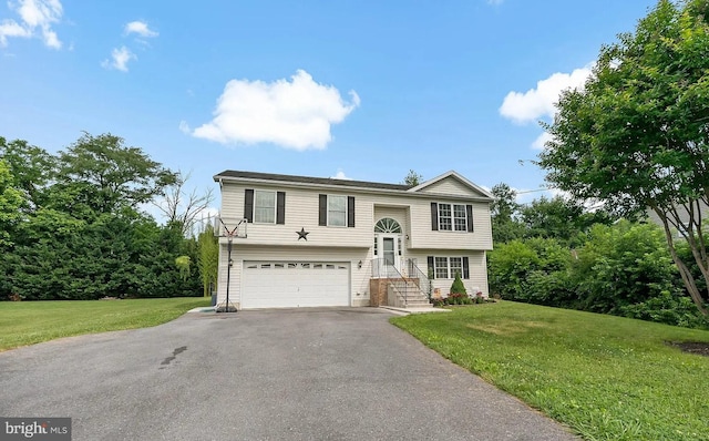 split foyer home featuring a front lawn and a garage