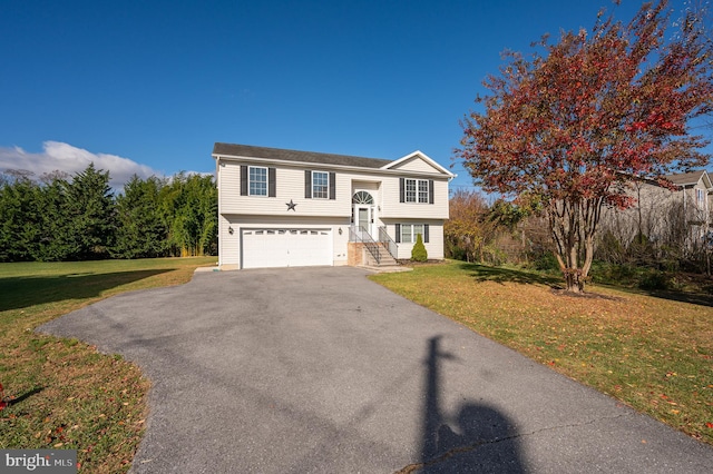 bi-level home featuring a garage and a front lawn