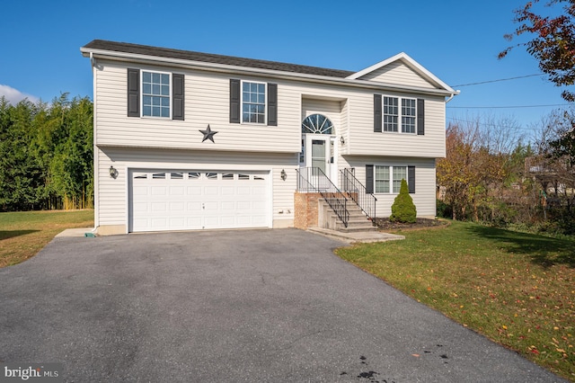 raised ranch featuring a front yard and a garage