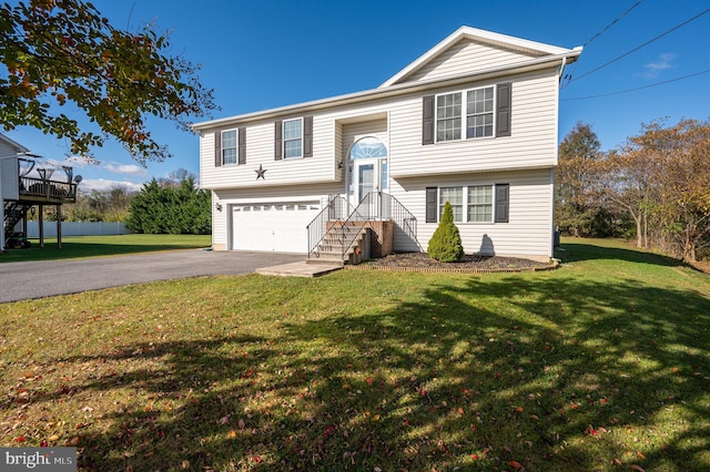 bi-level home with a garage and a front lawn