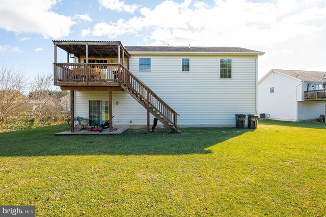 rear view of house with a lawn, a deck, and a patio