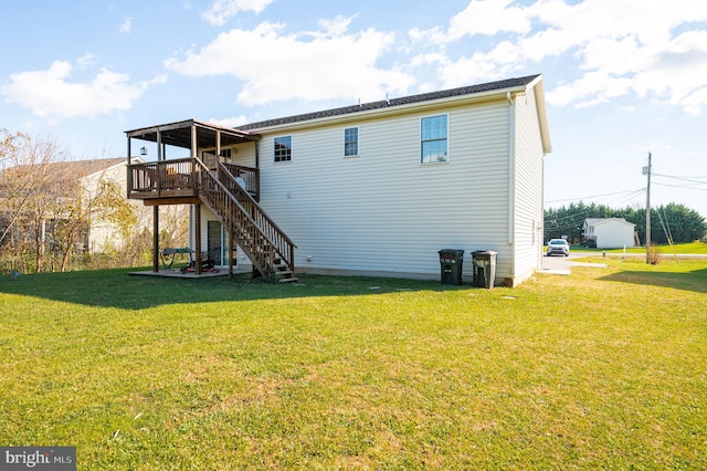 back of property with a yard and a wooden deck