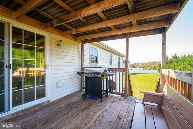 deck featuring area for grilling and a yard