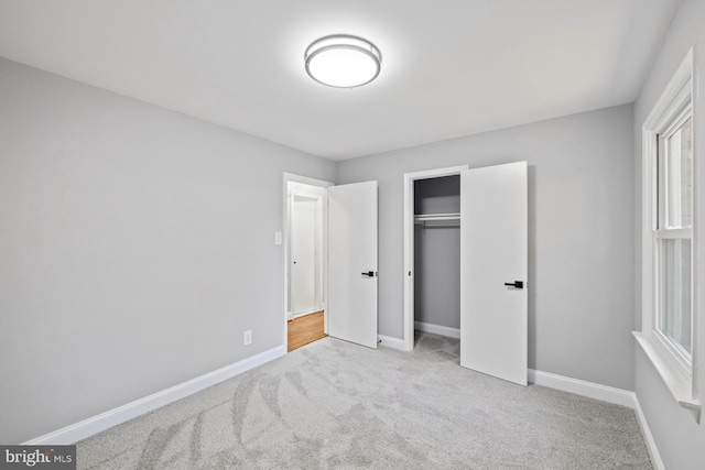 bedroom featuring light carpet and a closet