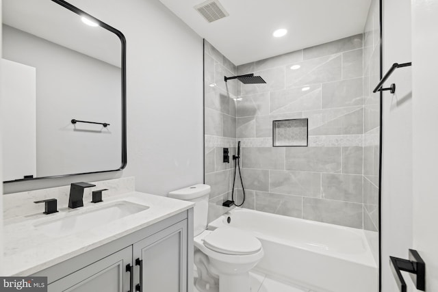 full bathroom featuring vanity, toilet, and tiled shower / bath