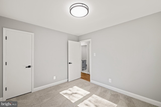 unfurnished bedroom featuring light colored carpet