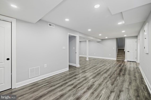 basement featuring dark hardwood / wood-style flooring