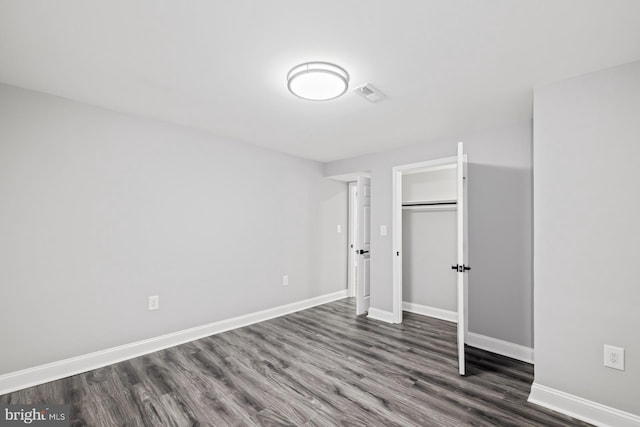 unfurnished bedroom featuring dark hardwood / wood-style flooring