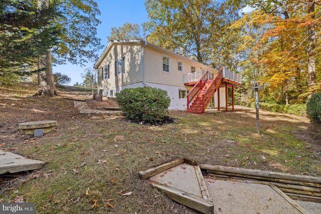 view of property exterior with a wooden deck