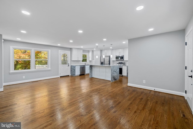 unfurnished living room featuring dark hardwood / wood-style flooring