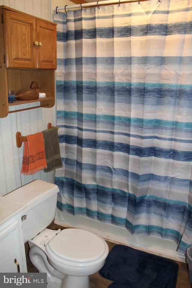 bathroom with toilet and shower / bath combo with shower curtain