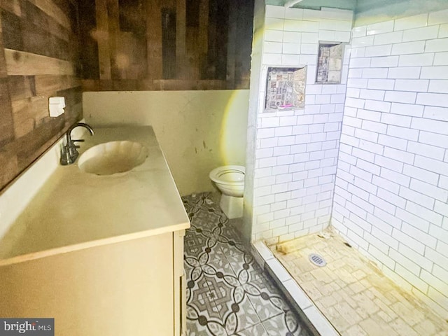 bathroom with a shower stall, tile patterned flooring, vanity, and toilet