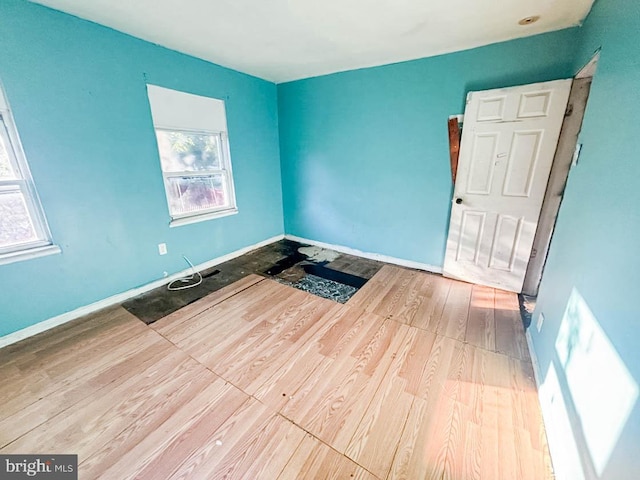 empty room featuring hardwood / wood-style floors and plenty of natural light